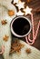 Christmas hot steaming cup of glint wine with spices, anise, cookies in a shape of star, red candies, pepper and gray scarf on