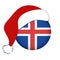 Christmas Iceland flag in circle shape. Isolated button of icelandic banner with Santa Claus hat.