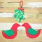 Christmas image of cute bird shapes cut out of felt that are kissing under mistletoe cut out of felt and tied with a red and white