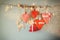 Christmas image of fabric red hearts and tree. wooden reindeer and garland lights, hanging on rope