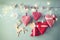 Christmas image of fabric red hearts and tree. wooden reindeer and garland lights, hanging on rope