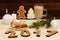 Christmas installation. Fir branch, gingerbread, pots, cake and candles on wooden background