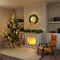 Christmas interior with decorated Christmas tree and gifts next to the burning fireplace and cozy chair. There are shelves with bo