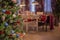 Christmas interior with a decorated Christmas tree and a laid table