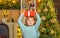 Christmas kids - happiness concept. Little Santa Claus gifting gift. Home Christmas atmosphere. Cheerful cute child