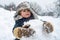 Christmas kids in snow. Cute little child boy on snowy field outdoor. Child boy Having Fun in Winter Park. Happy smiling