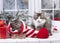 Christmas kittens, wearing Santa Claus hat sleeping on white plaid with blurry lights