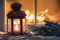 Christmas lantern with an illuminated window in background on a snowing night