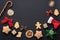 Christmas layout on a black background, New Year symbols: gingerbread cookies, bows, decorations for the New Year tree.