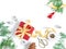 Christmas layout. The gift wrapped in red wrapping paper is tied with a yellow ribbon with a bow. Red cloth figurine of an angel,
