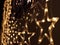 Christmas lighting decoration with bright LED lights in the shape of a gold star sparkles glitter.