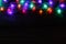 Christmas lights border on black wood background