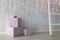 Christmas lights burning on a white wooden background with pink giftboxes and stairs