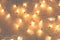 Christmas lights in the form of leaves on wooden background with copy space. Decorative garland.