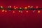 Christmas lights on red background. Multicolored lighton red background..