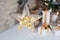 Christmas lights and wooden star with golden christmas decorations. large wooden star with many lights sparkles. Warm stars, light