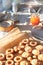 Christmas Linzer cookies filled with orange jam on cooling rack and vintage metal plate. Xmas stollen on table with