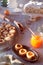 Christmas Linzer cookies filled with orange jam on cooling rack and vintage metal plate. Xmas stollen on table with