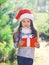 Christmas little girl child in santa hat with gift box