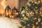 Christmas living room with a Christmas tree and gifts, candles, lanterns. Beautiful New Year decorated classic home interior. Wint