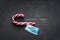 Christmas loading Concept - Candy cane on blackboard with christmas tree and surgical mask
