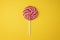 Christmas lollipop Candy top view on yellow background. Spiral lollipop flat lay closeup