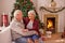 Christmas, love and senior couple on sofa in home bonding and affection. Xmas, romance and elderly, retired woman