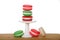 Christmas macaron cookies on a small pedestal on wood table isolated