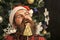 Christmas man with beard on happy face and lollipop.