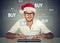 Christmas man in red santa claus hat buying stuff online