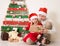 Christmas, x-mas, New Year, winter, holiday concept - smiling children in santa hats near creative wooden Christmas tree opening