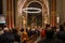 Christmas mass in the Catholic cathedral, people are sitting on the benches, near the altar, the Christmas choir performs