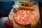 Christmas meal pizza with lemonade on the table with bundle of firewood