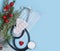 Christmas medical background. Stethoscope, medical mask, pills, heart, Christmas tree. Health concept in the context of