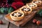 Christmas mincemeat tarts on a serving board. Table scene on rustic wood.