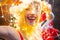 Christmas miracle magic lights. Smiling blonde Santa girl. Sexy woman in Snow Maiden costume. Christmas interior