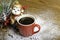 Christmas monkey near a red coffee cup.