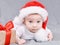 Christmas mood  baby. Cute surprised curious four month old caucasian baby in a Santa Claus hat