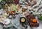 Christmas mood cozy home still life. Knitted plaid, sweater, books, green tea with honey, christmas toys, light garland, candle,