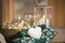 Christmas mood with snowball in shape of heart in hands with mittens  outdoor candle holder with burning candle