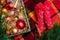 Christmas mood: wooden box with Xmas decoration of warm colors and feet in red socks with candy canes on checkered plaid