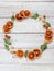 Christmas mood wreath made from dried orange slices, eucalyptus leaves, wooden stars and tiny bells with a copy space