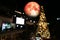 Christmas moon, Cold moon back over blur light christmas tree