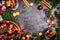 Christmas Mulled wine cooking preparation with pot, cups , ingredients and festive decorations on dark rustic background, top view