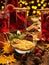 Christmas mulled wine or gluhwein with spices, chocolate candies, sweets and orange slices on rustic table, traditional drink on