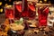 Christmas mulled wine or gluhwein with spices, chocolate sweets and orange slices on rustic table, traditional drink on winter