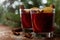 Christmas mulled wine or gluhwein with spices and orange slices on rustic table, traditional drink on winter holiday, magic light