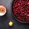 Christmas mulled wine ingredients. Lingonberry, cranberry, red berries, anise, cinnamon, orange on a dark background