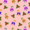 Christmas multicolored lollipops and holly seamless pattern on a pink background.