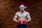 Christmas. Muscular Fighter kickbox boxing Santa Claus With Red Bandages the background of a brick wall.